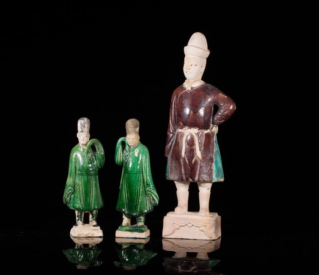 MING DYNASTY SANCAI POTTERY STANDING FIGURES: Three attendants in green and brown with glazing. H. of tallest 33.5cm (13 1/4 in.)