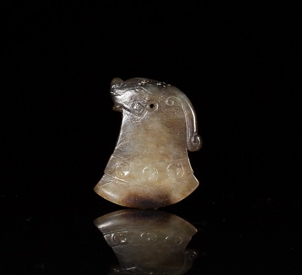 ARCHAISTIC FIGURAL JADE AXE PENDANT: Mottled brown jade with dragon head terminating in a decorative axe, possibly Han dynasty. H 4.8 cm. (1 7/8 in.) From the Irving Langleb collection, a prominent Jewish gentleman who resided in Japan p
