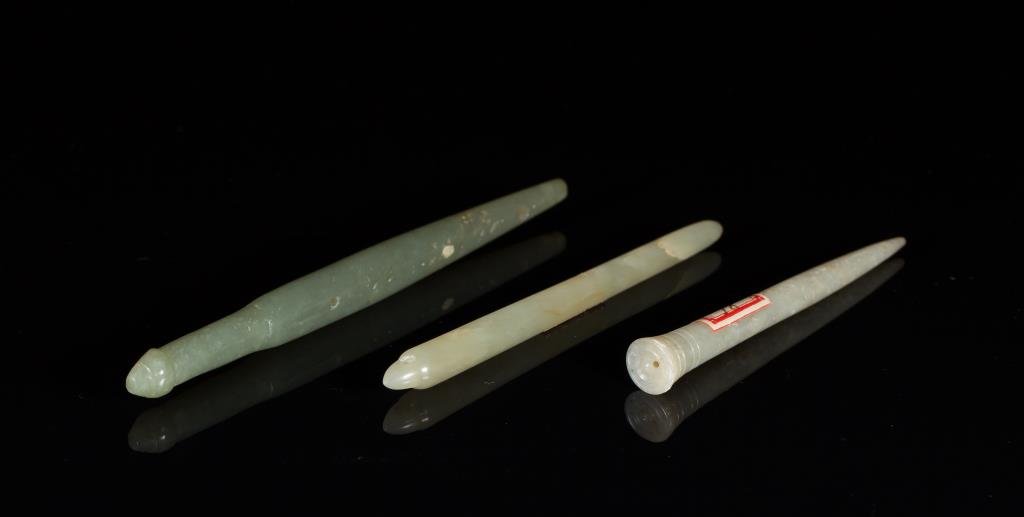 THREE GREEN JADE HAIR PIN PENDANTS: In dark and medium green, two of awl form, Ming Dynasty and earlier. L of dark green 12.7 cm. (5 in.) From the Irving Langleb collection, a prominent Jewish gentleman who resided in Japan post-WWII an