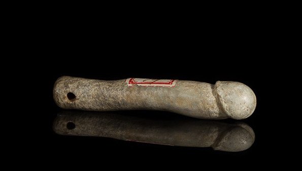 A CARVED JADE PHALLUS PENDANT: Mottled grey-green jade carved to stricking detail. L 8 cm. (3 1/8 in.) From the Irving Langleb collection, a prominent Jewish gentleman who resided in Japan post-WWII and was a close friend to Prince