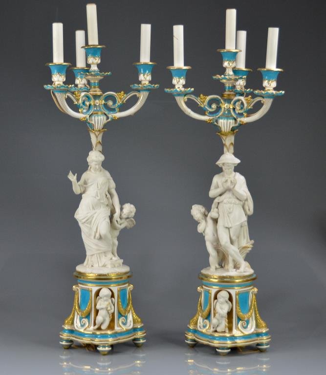 PAIR OF ATTRIBUTED MINTON PORCELAIN CANDELABRA: Turquoise and gilt classical base with two porticos, each set with Parian putti. Base supporting male and female figural four light candelabra. Design attributed to Klagmann, circa 1880. Height 75.5 c