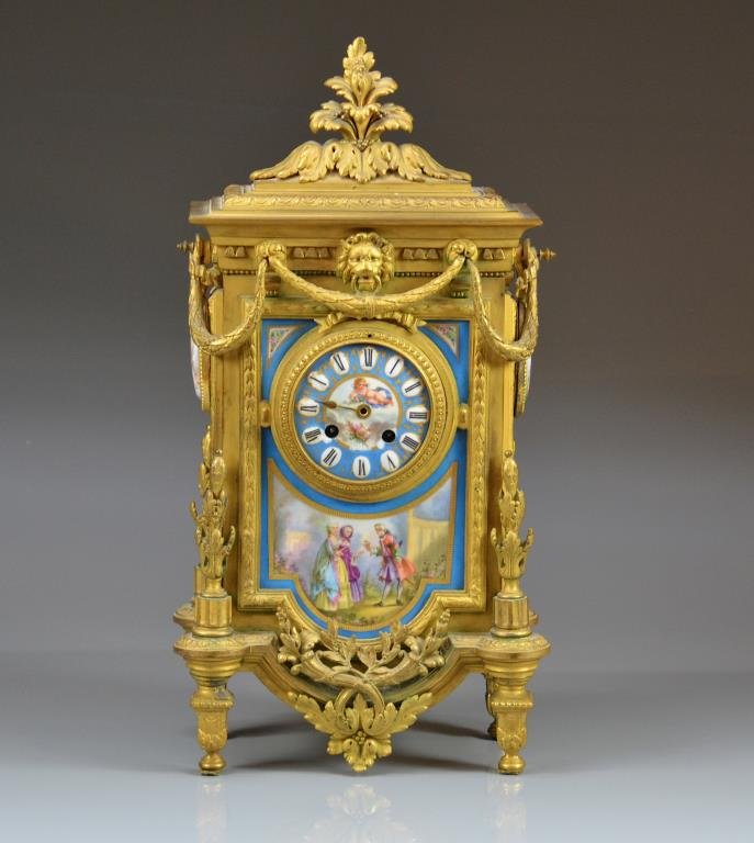 FRENCH BRONZE MANTLE CLOCK: Ormolu frame with swag and acanthus details. Sevres blue hand painted porcelain plaques and portrait mounts. Movement by Japy Freres. Model number 8209. Retailed by Miroy-Requier & Co., Paris, London.