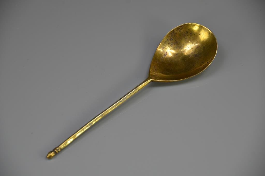 MEDIEVAL GILDED BRASS SPOON: An acorn finial spoon most likely English circa 1500. Marked on the back of the bowl with a star mark.