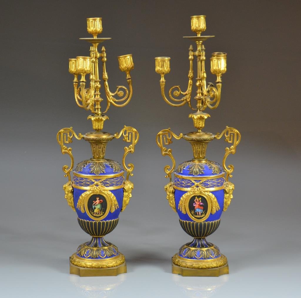 PAIR OF FRENCH BRONZE CANDELABRA: Matte cobalt to black porcelain urns, possibly KPM Berlin, with classical cartouches and ormolu mounts, handles cast with Bacchanalian grotesques. Height 49.5 cm. (19 1/2 in.). Good condition