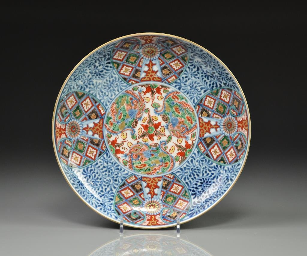 JAPANESE IMARI PORCELAIN PLATE: Painted with three dragons in centre against scrolling foliage, Jiaqin mark to base. Meiji period. Dia. 22.9cm (9 in.)