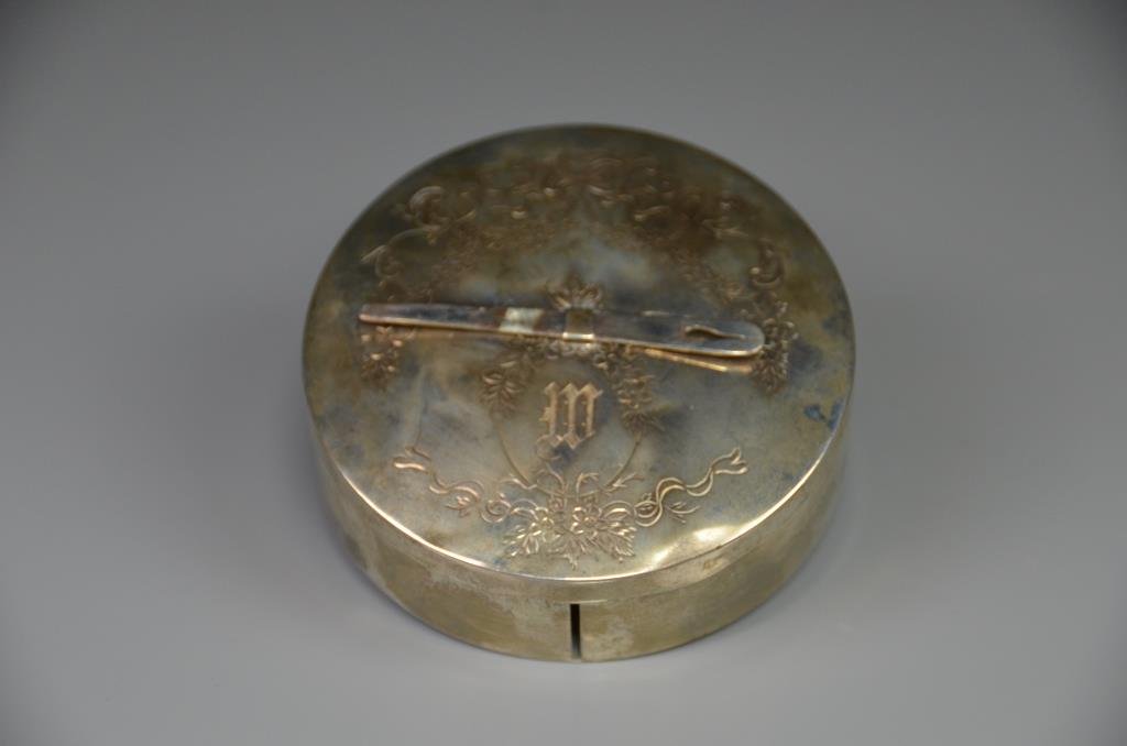 BIRKS SILVER RIBBON BOX: Circular with engraved scrolling motif, original needle on top, 101g. Dia 9.2 cm. (3 5/8 in.)