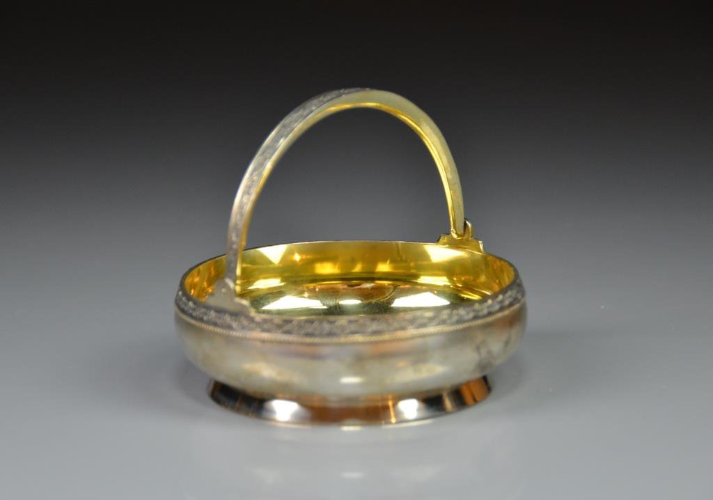 RUSSIAN SILVER SWING HANDLED BASKET: Beautiful gilt washed interior, Soviet marks, 159g. Dia 10.5 cm. (4 1/4 in.)