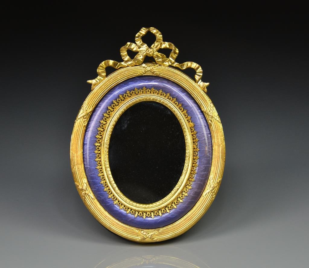 FRENCH GILT BRONZE & ENAMEL FRAME: Ribboned frame with an interior band of purple guilloche enamel, back plate marked France. H 16.5 cm. (6 1/2 in.)
