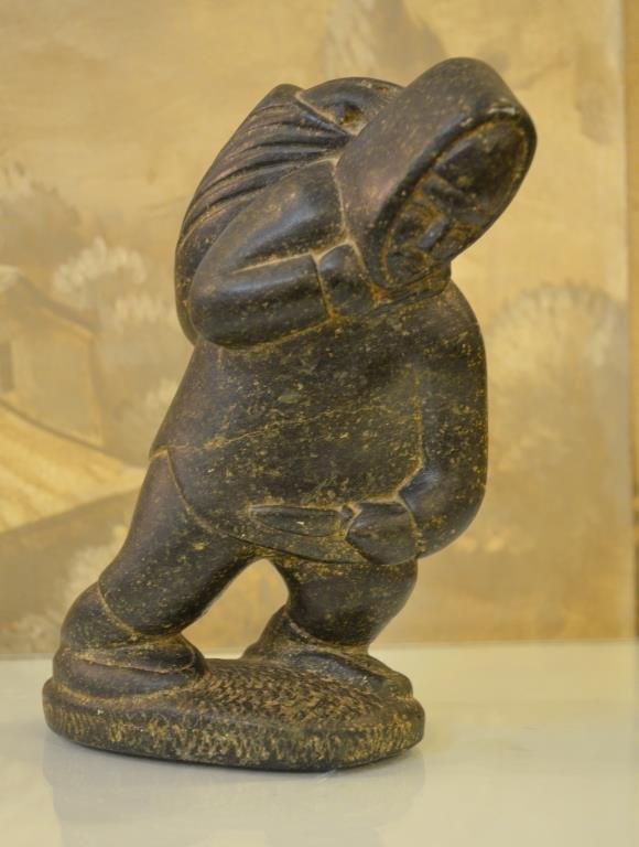 Samson NASTAPOKA (Inukjuak, 1931): HUNTER WITH FISH, soapstone, etched on the bottom with artist name, H: 9" / 23cm