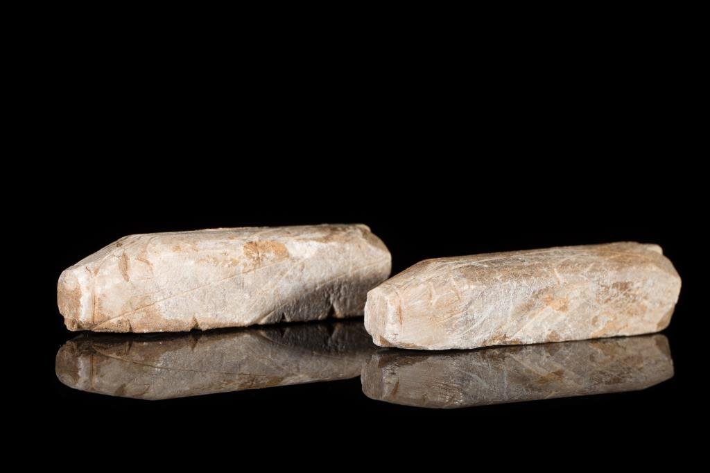 PAIR OF CHINESE STONE 8-CUT BURIAL PIGS: Possibly of soapstone or calcite, cut on three sides with a flat base, Han or Song Dynasty. L 9.5 cm. (3 3/4 in.) Provenance: From the Irving Langleb collection, a prominent Jewish gentleman who resid
