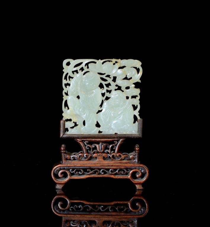 CHINESE CELADON JADE HE-HE TWIN PLAQUE: Square form plaque carved and pierced with He-He twins each holding lotus flower and lingzhi. On a finely carved fitted wood stand. H. of jade plaque 7cm (2 3/4 in.)