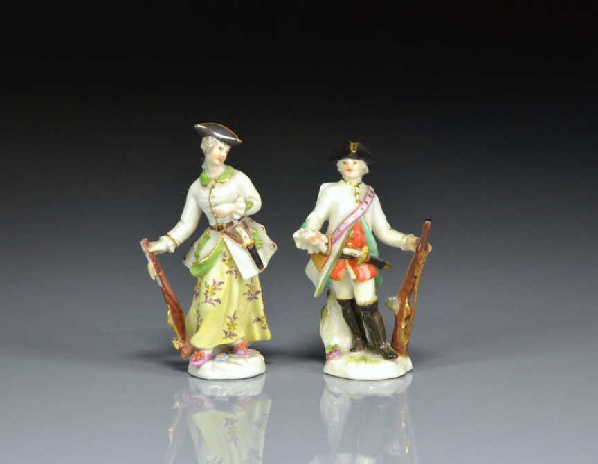 PAIR OF MEISSEN PORCELAIN HUNTING FIGURES: Each holding a rifle, with Meissen blue cross marks on the bottom, H: 8cm (3 1/4 in.)