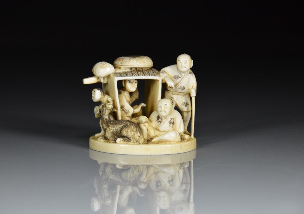 IVORY OKIMONO WITH FIGURES AND GOAT: Intricately carved with figures reclining with goat. L 7.5cm (3 in.), H: 6cm (2 1/2 in.)