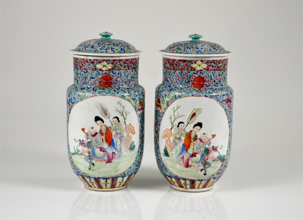 PAIR OF CHINESE TURQUOISE GROUND FAMILLE ROSE JARS: Covered jars with windows depicting a woman and child riding a dragon with attendant, and bamboo and floral motif on the other. Each vase are mirror images of each other. six character marks to base, 