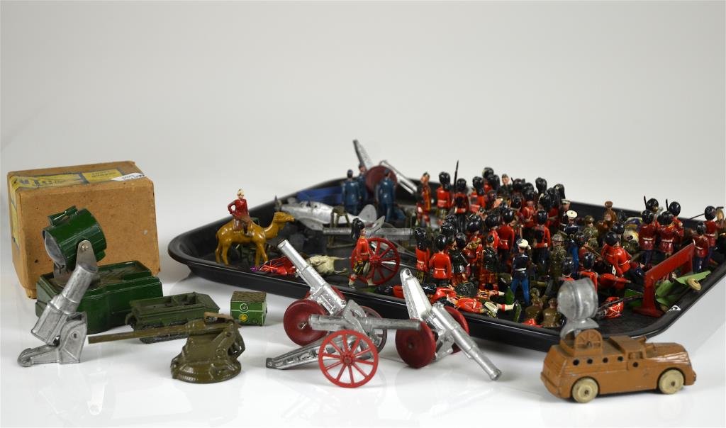 LARGE LOT OF BRITTANIA PAINTED SOLDIERS: Including: horse mounted soldiers, Queen's guards, military uniforms, a cased Astra search light, Canadian & American made canons, and dinky toys flying boat MAIA.