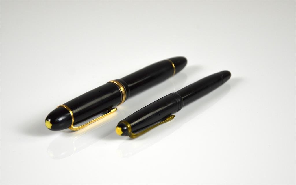 MONT BLANC MEISTERSTUCK 149 FOUNTAIN PEN: Black resin with red gold-coated details, surmounted by the white star emblem and finished with a handcrafted gold nib. Marked 14C Montblanc 585. Together with another Monblanc fountain pen.