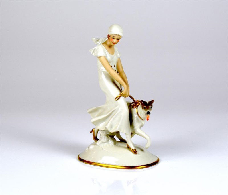 PIRKENHAMMER PORCELAIN FIGURE WITH GREYHOUND: Fischer & Mieg, Pirkenhammer porcelain figure of a wonman wling a greyhound. Manufacturer's mark with gold stock and additional '' Art China 1803 '', pressed model no. 4154. H. 22cm (8 3/4 in.)