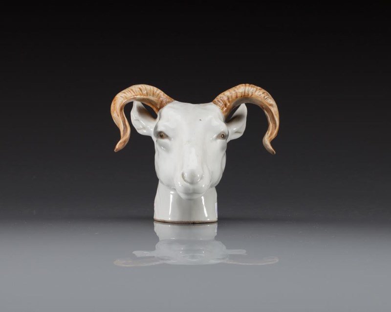 CHINESE EXPORT FIGURAL INCENSE HOLDER: Of a ram's head glazed in white, with the eyes and horns glazed n brown. Hole to top likely served as an incense holder. H. 12 (4 3/4 in.)