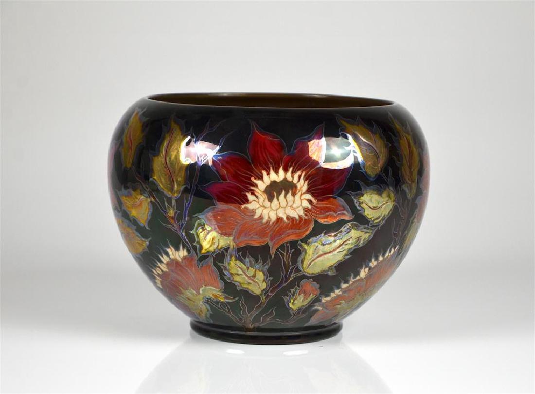 HUNGARIAN ZSOLNAY LUSTER BOWL: Signed by Ilona Bardonocsek. Number 644/2057, a dark underglaze decorated with various flowers. H 15.2 cm (6 in.). W 20.3 cm (8 in.) Formally Zsolnay Porcelánmanufaktúra Zrt (Zsolnay Porcelain Manuf