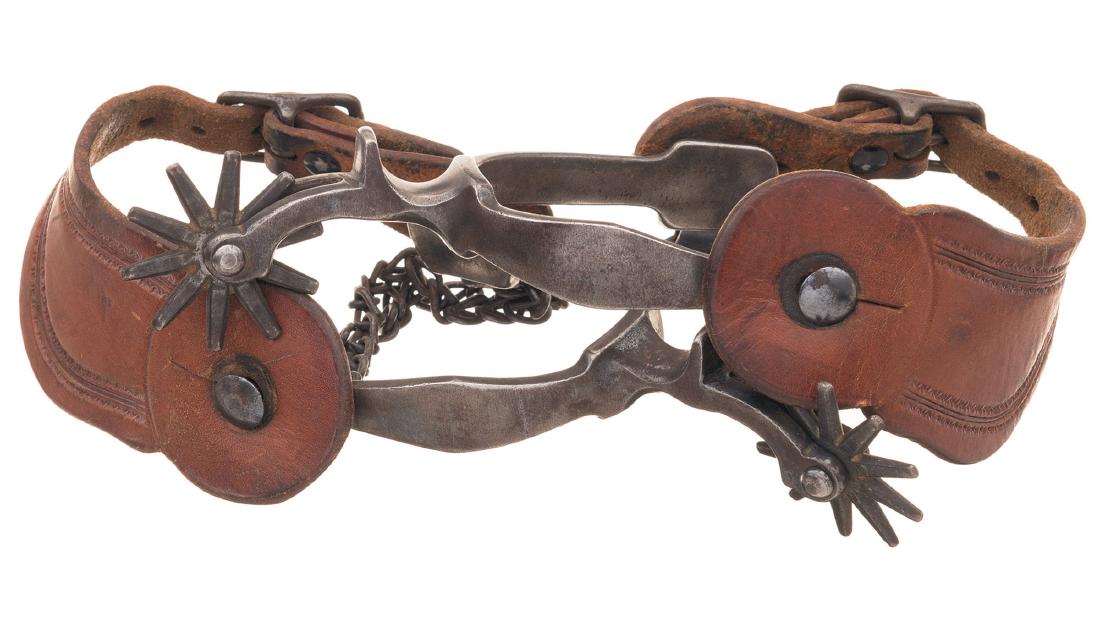 Three Pairs of Spurs with Leather Straps: Three Pairs of Spurs, Including A. Buermann 1) Unmarked pair of August Buermann style spurs, drop shanks with chap guards, spoked rowels, heel chain attachments (no chains), and smooth leather straps.