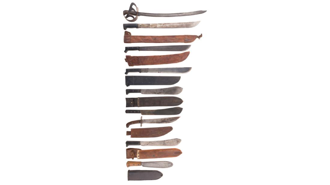 Thirteen Edged Weapons: Thirteen Edged Weapons The grouping includes a "HEMBRUG" marked sword, seven machetes (mostly American, a mix of military and commercial), a USMC Corpsman's knife, and a Collins-Legitimus bowie knife.