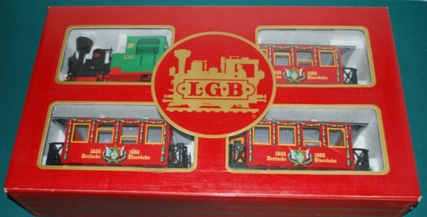 LGB 150th Anniversary Train Set G Scale: This Lot is a LGB 150th Anniversary Train Set G Scale. The train consists of a 0-4-0 engine and three cars. It comes in the original box. We see no discernable wear on the vehicle or wheels and believ