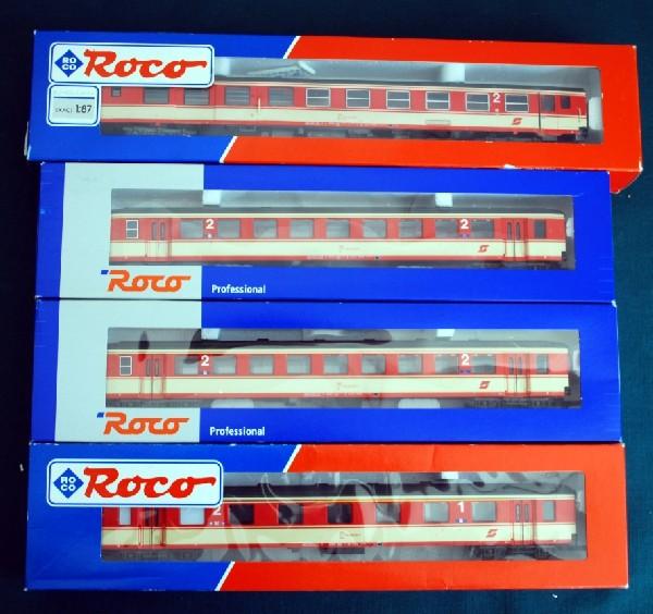 4 OBB Commuter Cars Roco HO Scale DC: 4 OBB Commuter Cars Roco HO Scale DC. The models appear to be in the original boxes and packing. We see that the Austrian Car models feature European style couplers. The models are with interior detai