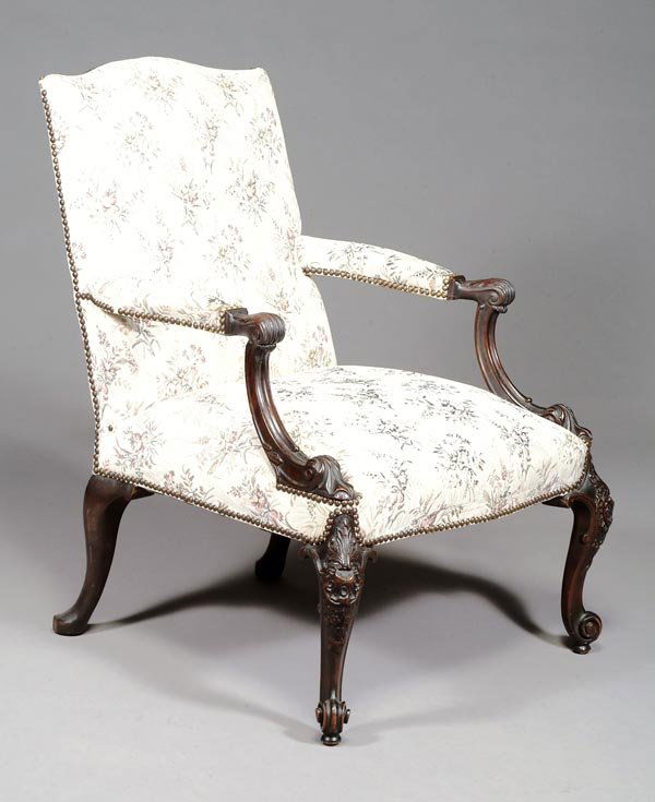 A mahogany framed and upholstered 'Gainsborou: A mahogany framed and upholstered 'Gainsborough'armchair, in George III style , circa 1900, inthe manner of Thomas Chippendale, with studdedupholstered back, above upholstered armrests and scrolling d