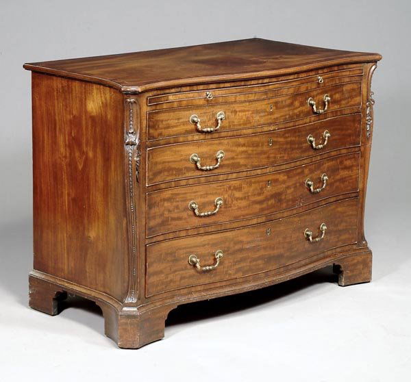 A George III mahogany and crossbanded serpent: A George III mahogany and crossbanded serpentinefronted chest of drawers, circa 1770, in themanner of Thomas Chippendale, with a baize linedbrushing slide, above four graduated drawersflanked by scrol