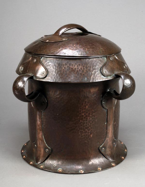 An Arts and Crafts hammered copper coal box andcov: Signed: An Arts and Crafts hammered copper coal box andcover, with moulded stylised foliate strap'handles', 40cm high (t
