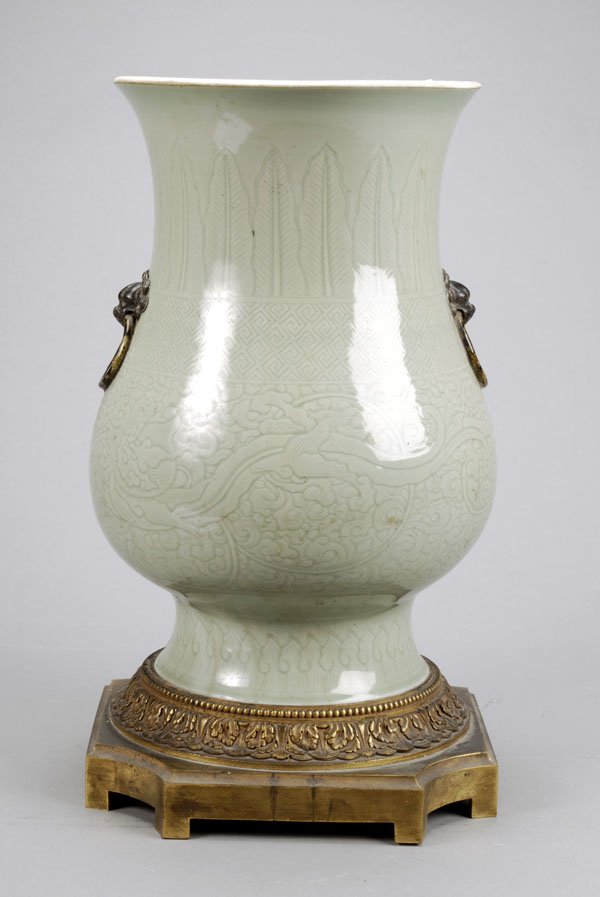 A Chinese carved celadon-glazed vase, Kangxi,decor: A Chinese carved celadon-glazed vase, Kangxi,decorated with bands of lappets, Greek key andtwo chilong beasts amongst lingzhi fun