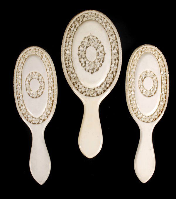Three Chinese ivory hand mirrors, late 19thcentury: Three Chinese ivory hand mirrors, late 19thcentury, each carved to the back in high reliefwith bands of flowers, two mirrors with i