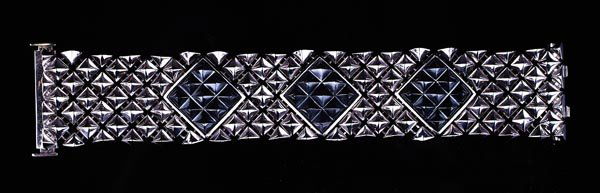 An 18ct white gold and hematite cuff bracelet by S: An 18ct white gold and hematite cuff bracelet by Stephen Webster, composed of flexible hobnail links with three carved hobnail hema