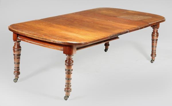 A Victorian walnut extending dining table, circa 1: A Victorian walnut extending dining table, circa 1880, with three additional leaves, on turned legs, 74cm high, the top approximately 132cm x 232cm overall