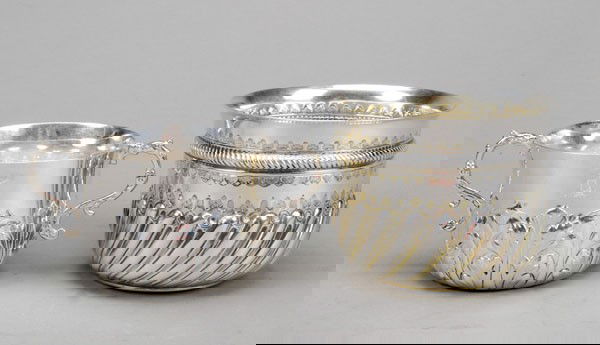 A late Victorian silver parcel gilt deep bowl by C: A late Victorian silver parcel gilt deep bowl by Charles Stuart Harris jnr., London 1895, with punched trefoil bands, an embossed cable girdle and half gadrooning, the base inset with a Willi