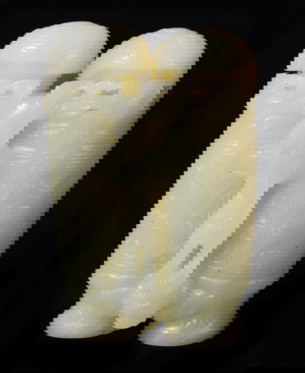 A Chinese pale celadon jade miniature double vase: A Chinese pale celadon jade miniature double vase and covers, carved in low relief with archaistic scrolls stylised deer figures and bats, the stone with tan inclusions, 6cm high