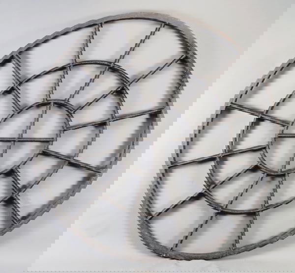 A pair of George III circular cast iron window fra: A pair of George III circular cast iron window frames, circa 1790, each of radiating form with cruciform centres, 140cm diameter, 4.5cm thick. Provenance: St Luke's Church, London. St Luke's