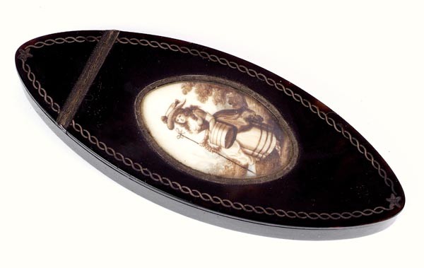 A George III tortoiseshell navette shape patch box: A George III tortoiseshell navette shape patch box, circa 1800, the cover inset with an oval sepia wash on ivory plaque painted with a lady of fashion as a milkmaid, with an inlaid pewter bor