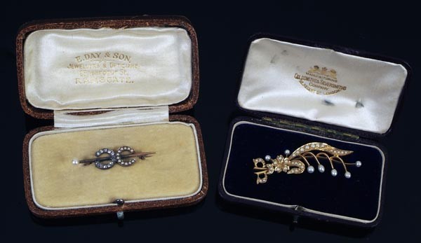 A late Victorian half pearl and diamond double 'C': A late Victorian half pearl and diamond double 'C' brooch, circa 1900, one C set with cushion shaped old cut diamonds, the other with half pearls, on a pin bar with a 4mm pearl terminal, 3.8c