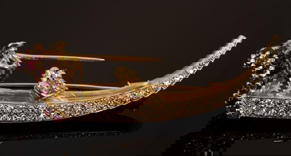 A French garnet, ruby and diamond gondola brooch b: A French garnet, ruby and diamond gondola brooch by Gian Luca, modelled with a seated romantic couple and gondolier in an eight cut diamond set boat with circular cut ruby and garnet back res