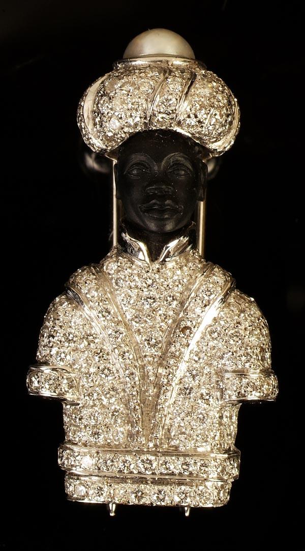 A French diamond blackamoor brooch, the blackamoor: A French diamond blackamoor brooch, the blackamoor's jacket pavé set with brilliant cut diamonds, his turban with a half pearl crown and pavé set diamonds, French poin?ons to the pin, 3.6cm