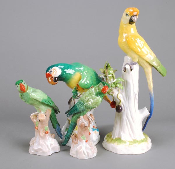 A Meissen model of a brightly coloured parrot, per: A Meissen model of a brightly coloured parrot, perched on a stump, 19cm high, blue crossed swords mark, incised 644 ; and three various Dresden models of parrots, 20th century
