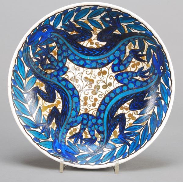 An Arts and Crafts pottery dish by John Pearson, p: An Arts and Crafts pottery dish by John Pearson, painted with three salamanders amongst foliage, in shades of blue and green with gold lustre, painted 'JP' monogram, 24cm diameter
