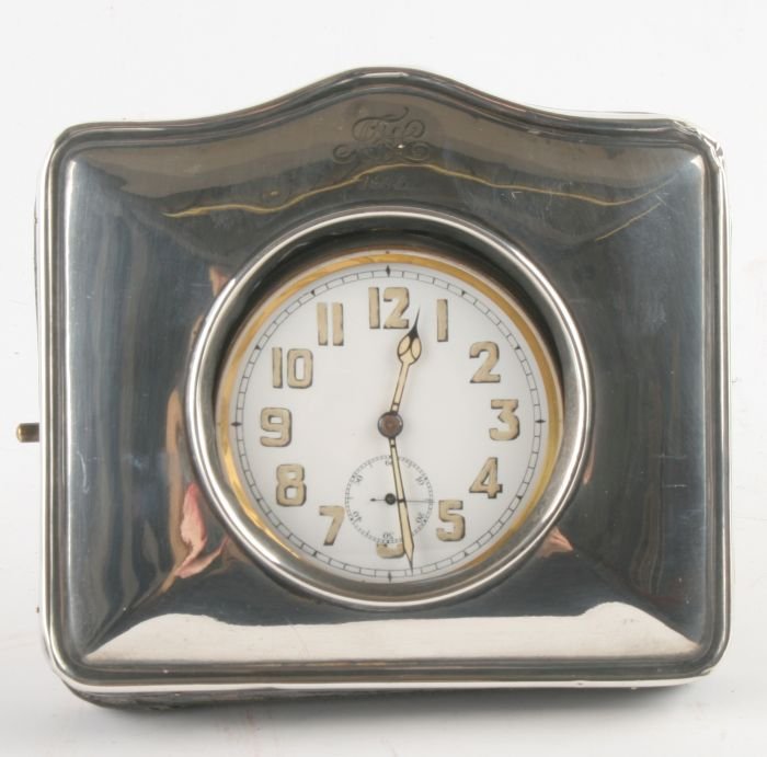 A silver fronted travelling case for a Goliath poc: A silver fronted travelling case for a Goliath pocket watch, by H.Matthews, Birmingham 1915, of plain square arched form, with a metal pocketwatch