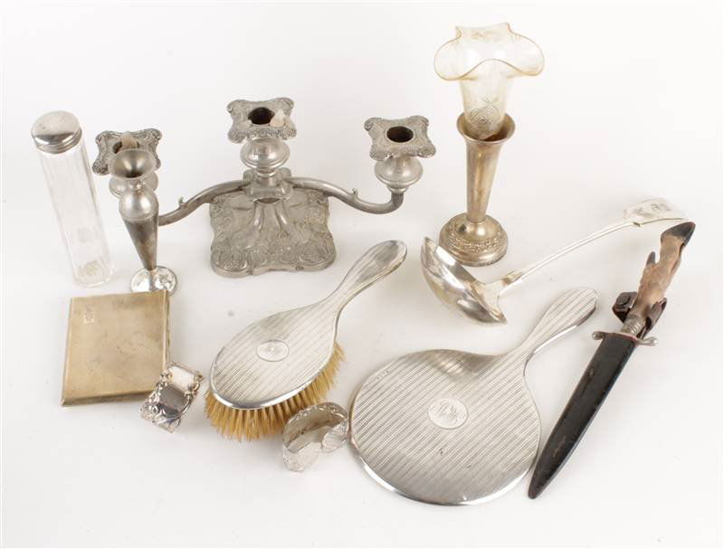 A silver hand mirror and matching hair brush; a pl: A silver hand mirror and matching hair brush; a plated soup ladle; a pair of plated napkin rings; a plated three light dwarf candelabra; two plated bud vases; a toilet bottle; a gilt metal ci