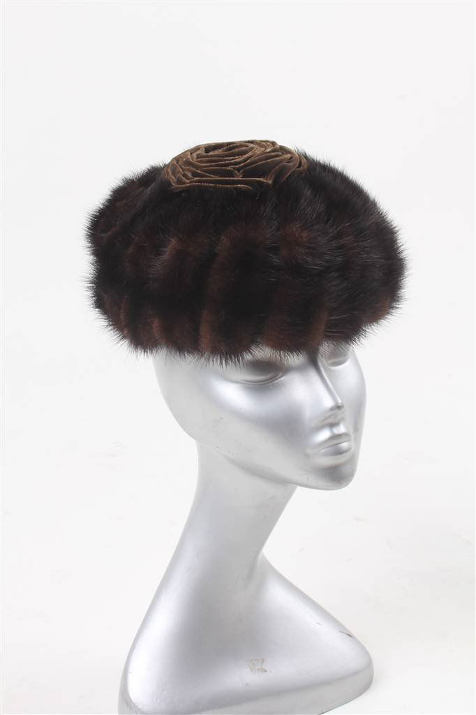 A 1960s Christian Dior white fur hat; together wit: A 1960s Christian Dior white fur hat; together with a collection of 1950s-1960s fur hats, including a mink example; a brown velvet riding hat; a feather hat; a pair of 1960s shoes; a collection of hat