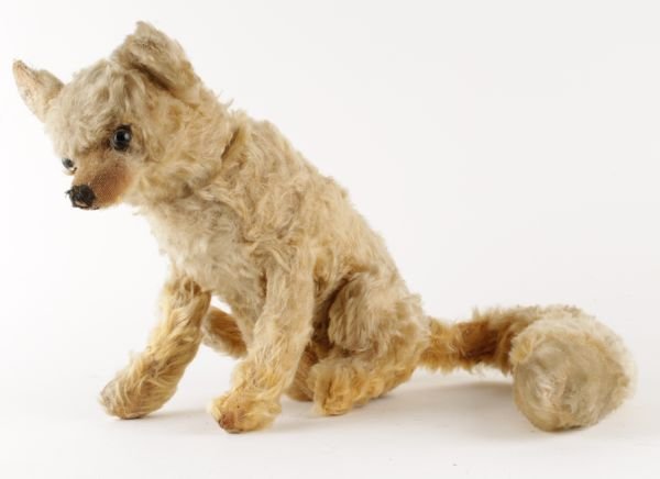 A gold mohair seated fox soft toy, with glass eye