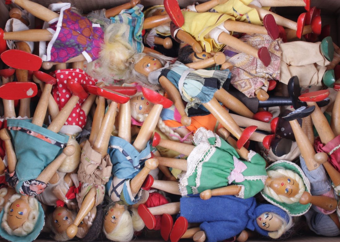 Sixty Polish wooden dolls, each with wig, painted