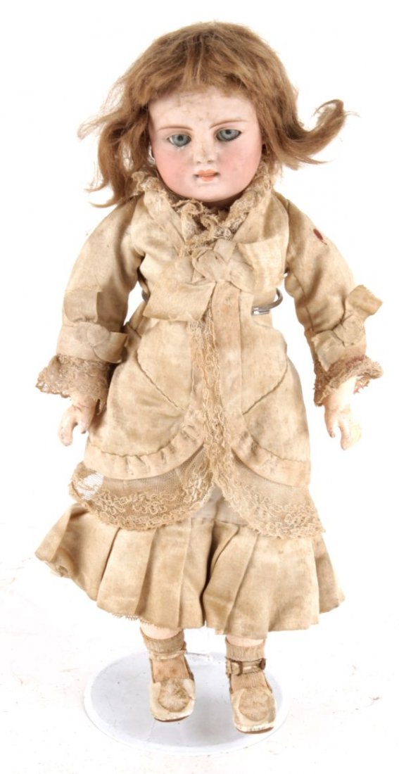 A bisque socket-head doll, with a brown wig, slee