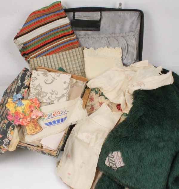 A pair of 1920s silk pyjamas, in a vintage suitca